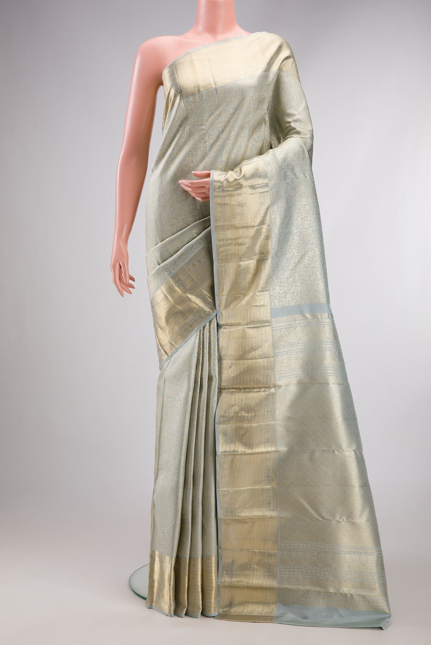 Grey Kanchipuram Silk Saree with Zari Brocade on the body and Zari Border.  displayed on a mannequin