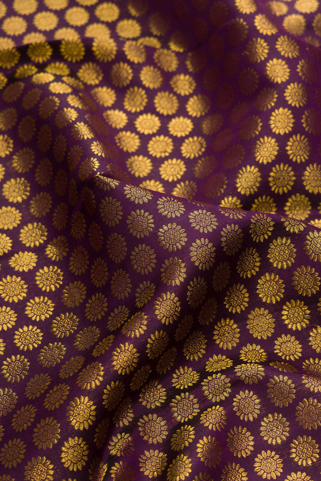 Close up of Pure Silk Burgundy Dual Tone Kanchipuram Saree with Zari Brocade on the body and Zari Border.  displaying folds
