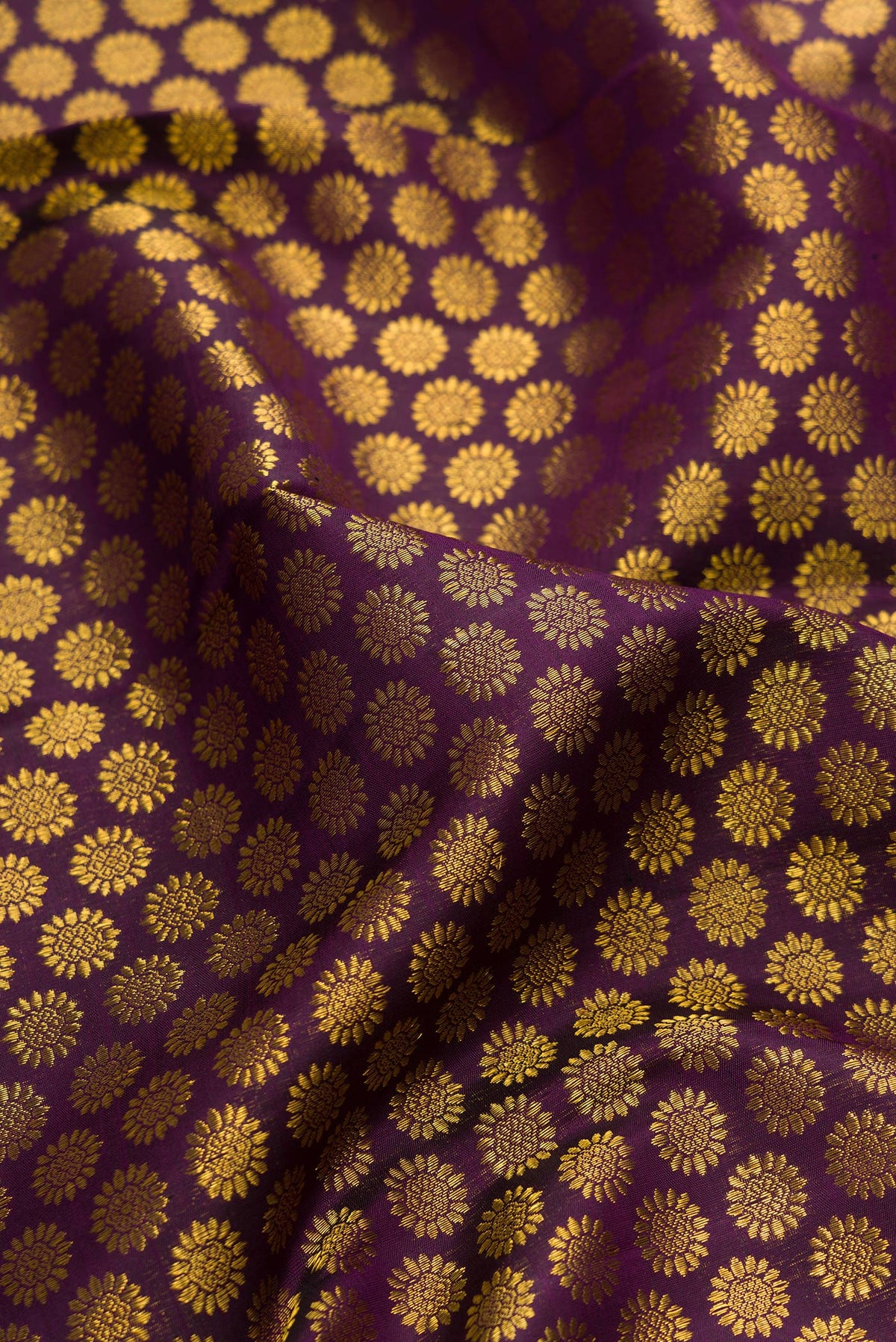 Close up of Pure Silk Burgundy Dual Tone Kanchipuram Saree with Zari Brocade on the body and Zari Border.  displaying folds