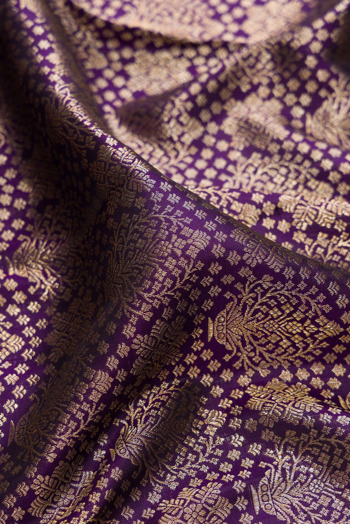 Close up of Pure Silk Violet Kanchipuram Saree with Zari Brocade on the body and Zari Border.  displaying folds