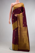 Coffee Brown Kanchipuram Silk Saree with Zari Butta on the body and Zari Border.  displayed on a mannequin