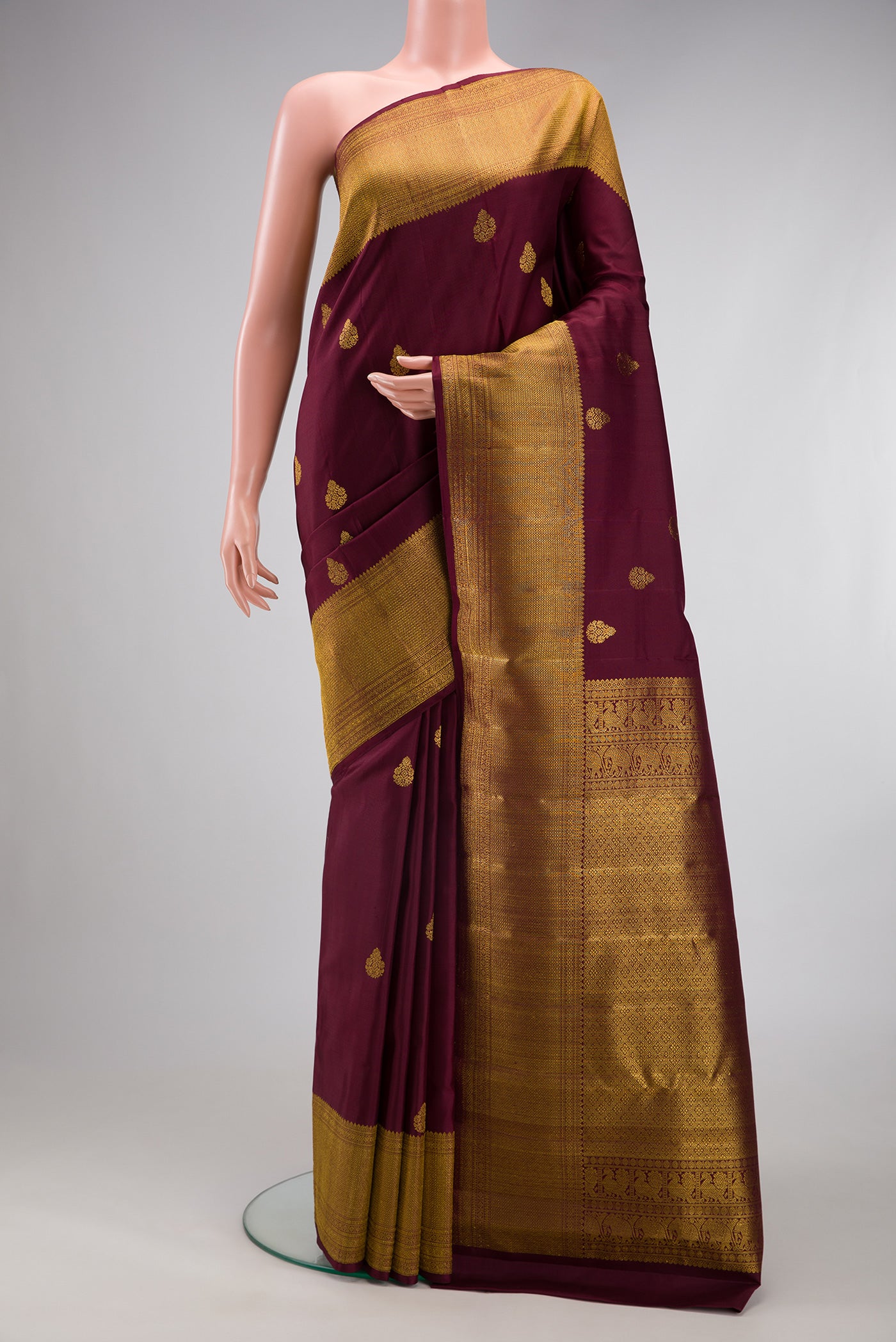 Coffee Brown Kanchipuram Silk Saree with Zari Butta on the body and Zari Border.  displayed on a mannequin
