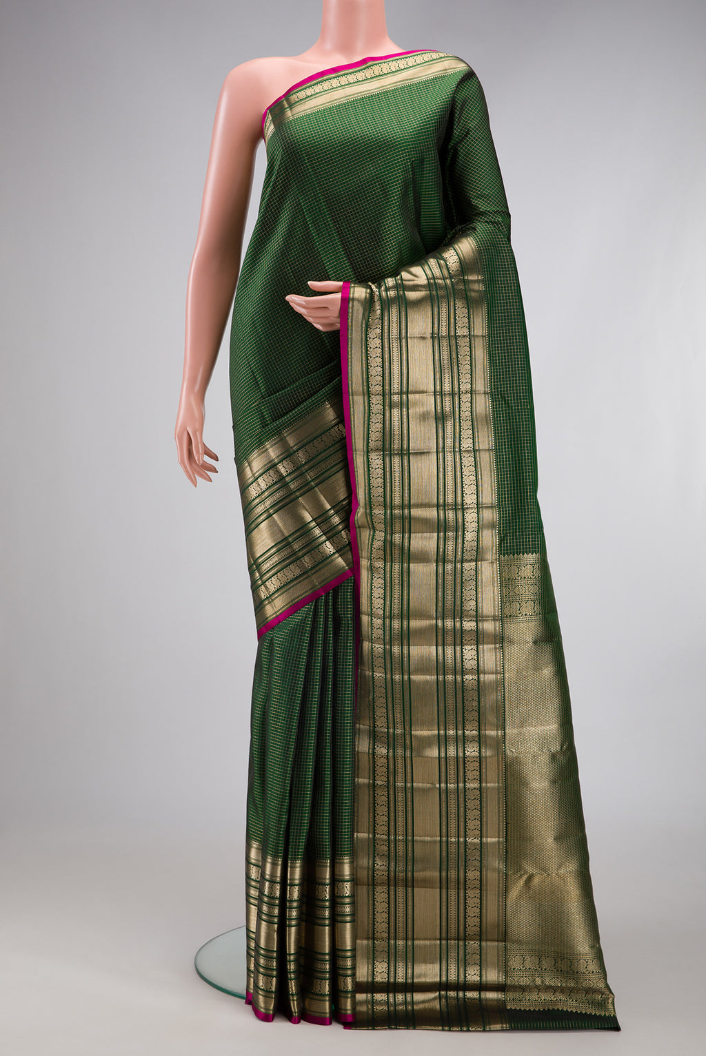 Bottle Green Kanchipuram Silk Saree with Checked design on the body and Zari Border.  displayed on a mannequin