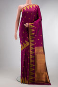 Magenta Kanchipuram Silk Saree with Zari Butta on the body and Temple Border.  displayed on a mannequin