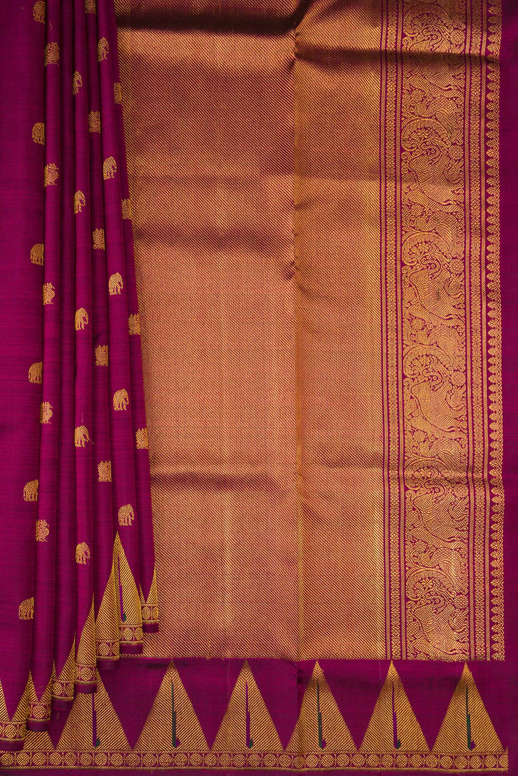 Pleats and pallu of Magenta Kanchipuram Silk Saree with Zari Butta on the body and Temple Border. 