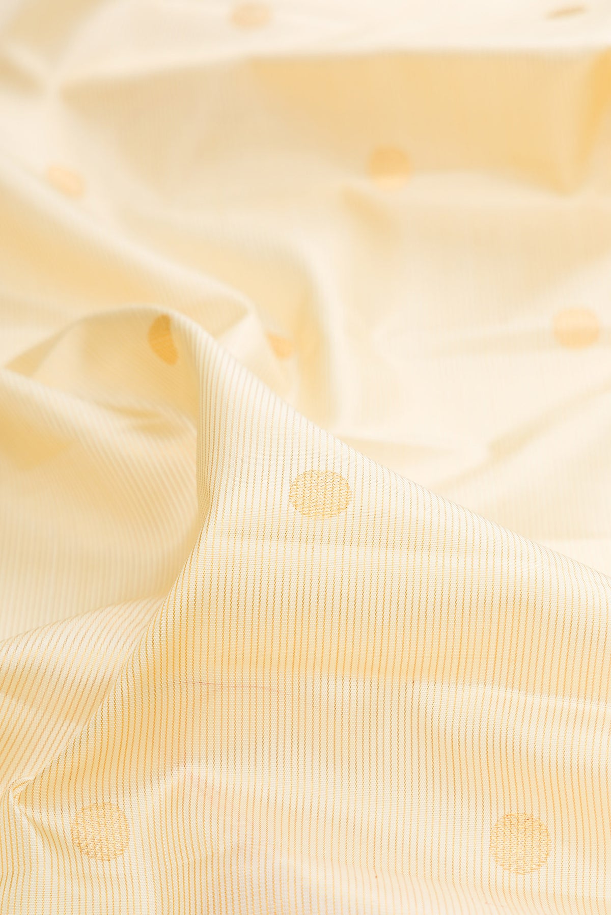 Close up of Pure Silk Sandal Kanchipuram Saree with Zari Butta on the body and Zari Border.  displaying folds