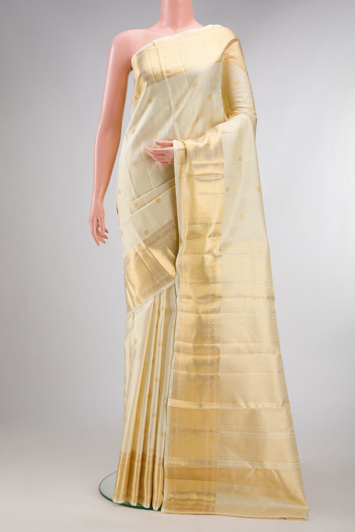 Pure Silk Sandal Kanchipuram Saree with Zari Butta on the body and Zari Border.  displayed on a mannequin