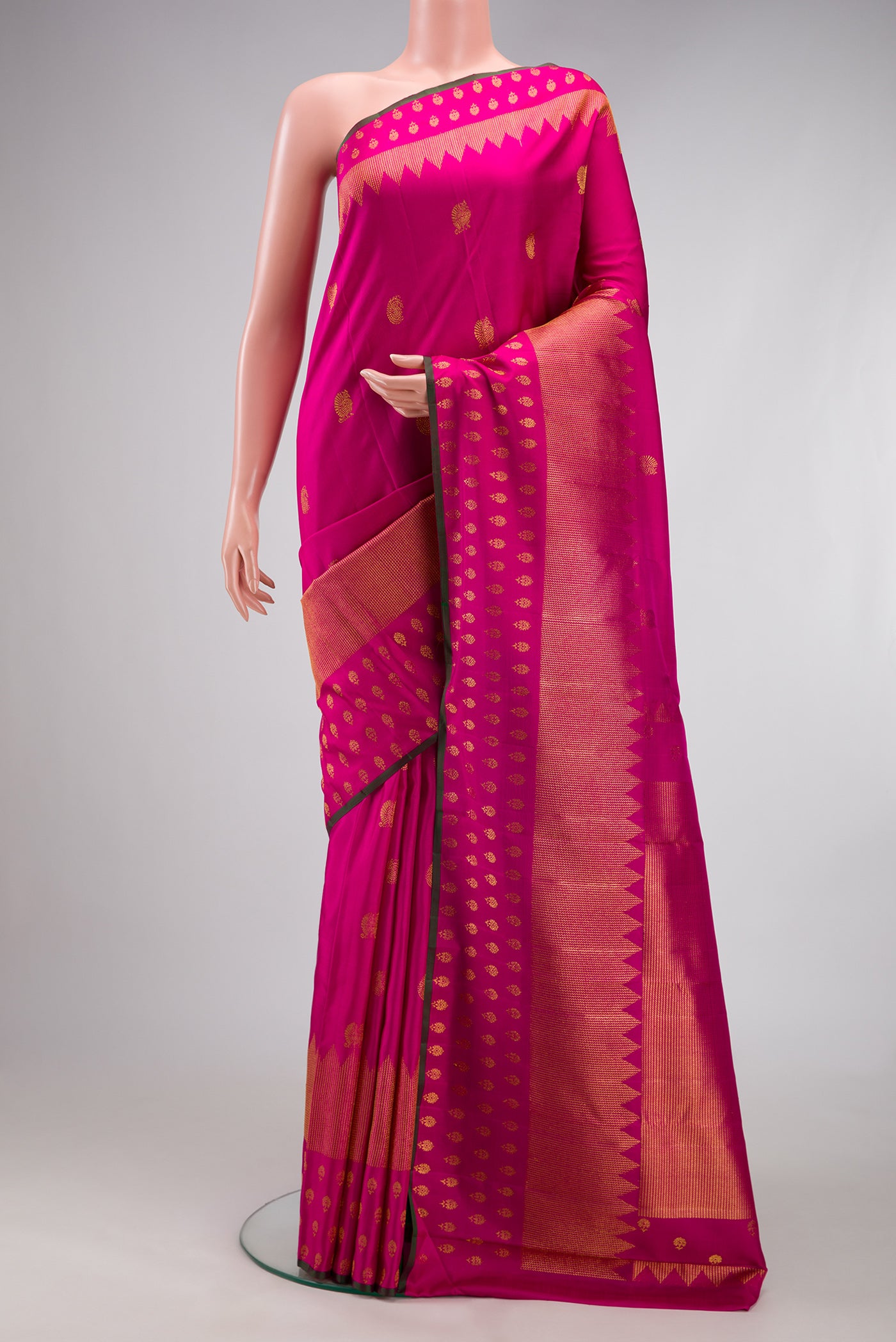 Dark Pink Kanchipuram Silk Saree with Zari Butta on the body and Fancy Border.  displayed on a mannequin