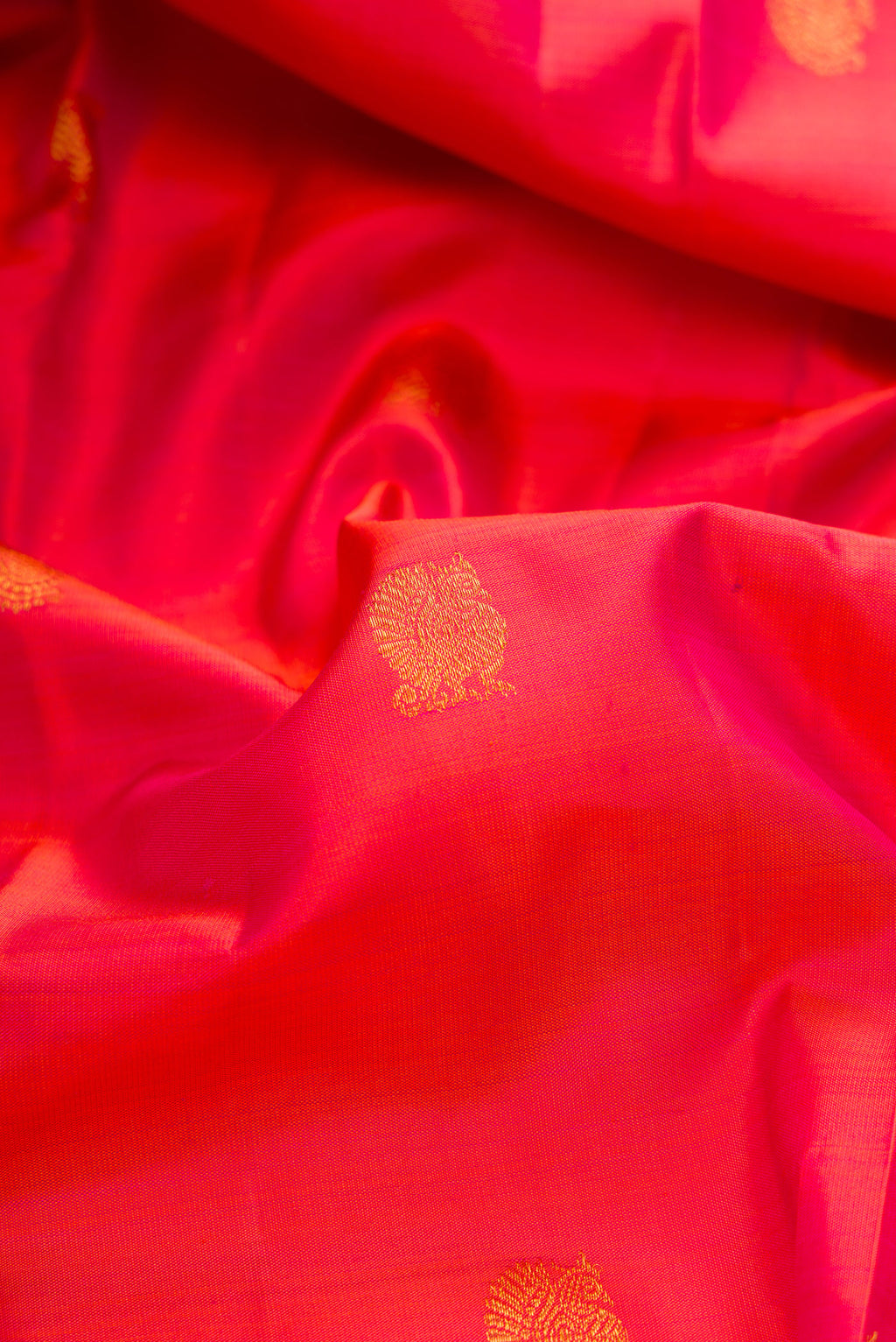 Close up of Pink Dual Tone Kanchipuram Silk Saree with Zari Butta on the body and Fancy Border.  displaying folds