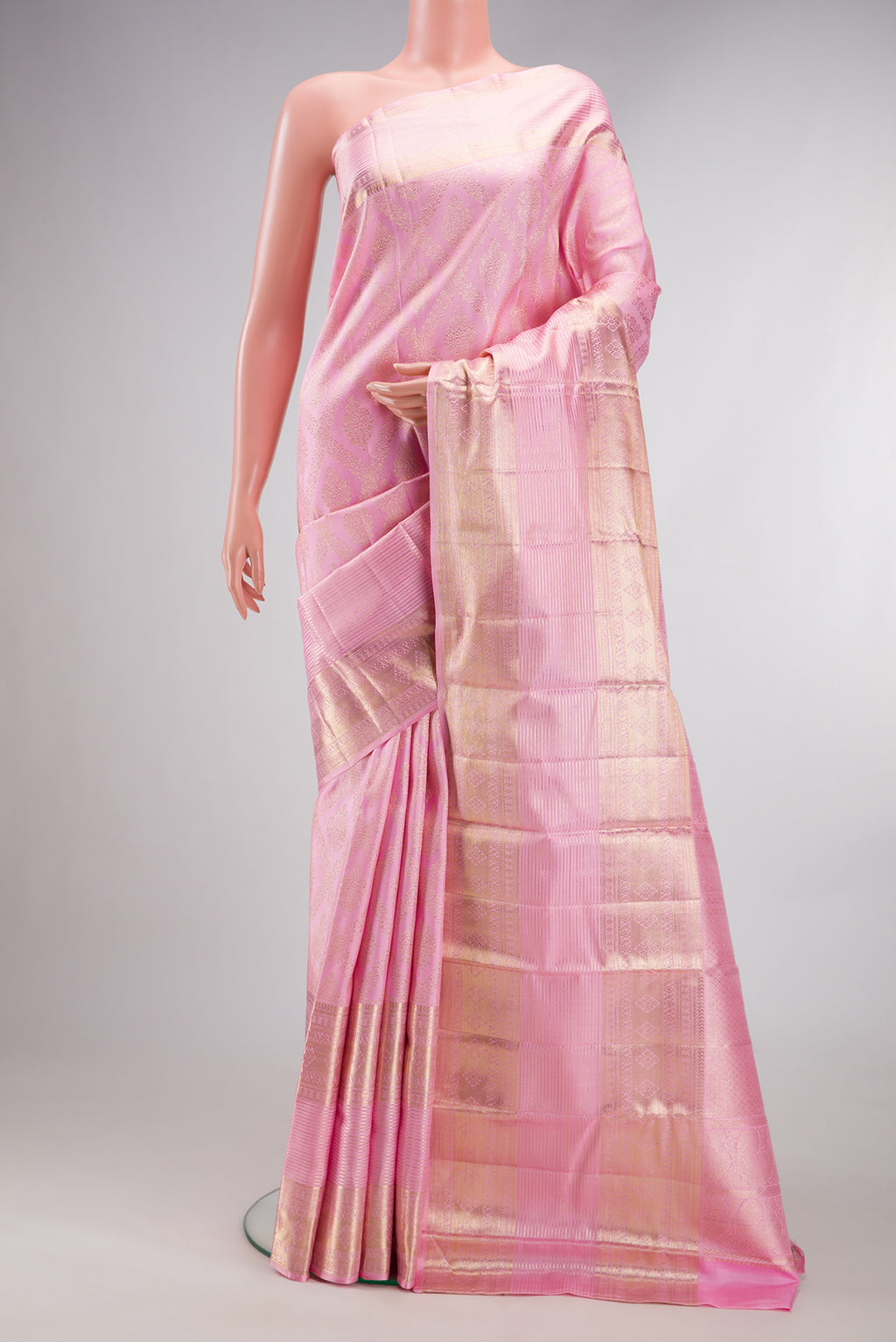 Pure Silk Rose pink Kanchipuram Saree with Zari Brocade on the body and Zari Border.  displayed on a mannequin