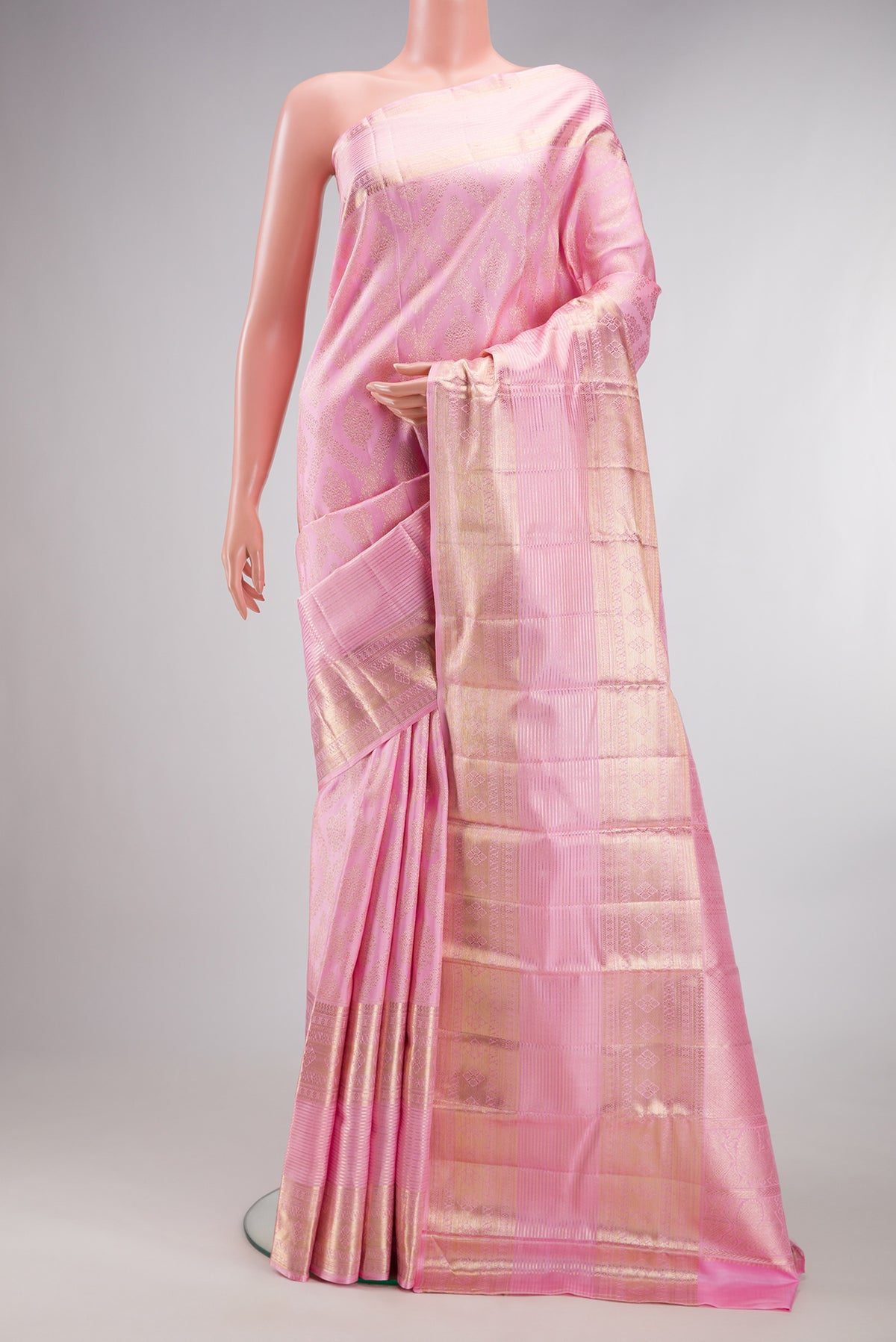 Pure Silk Rose pink Kanchipuram Saree with Zari Brocade on the body and Zari Border.  displayed on a mannequin