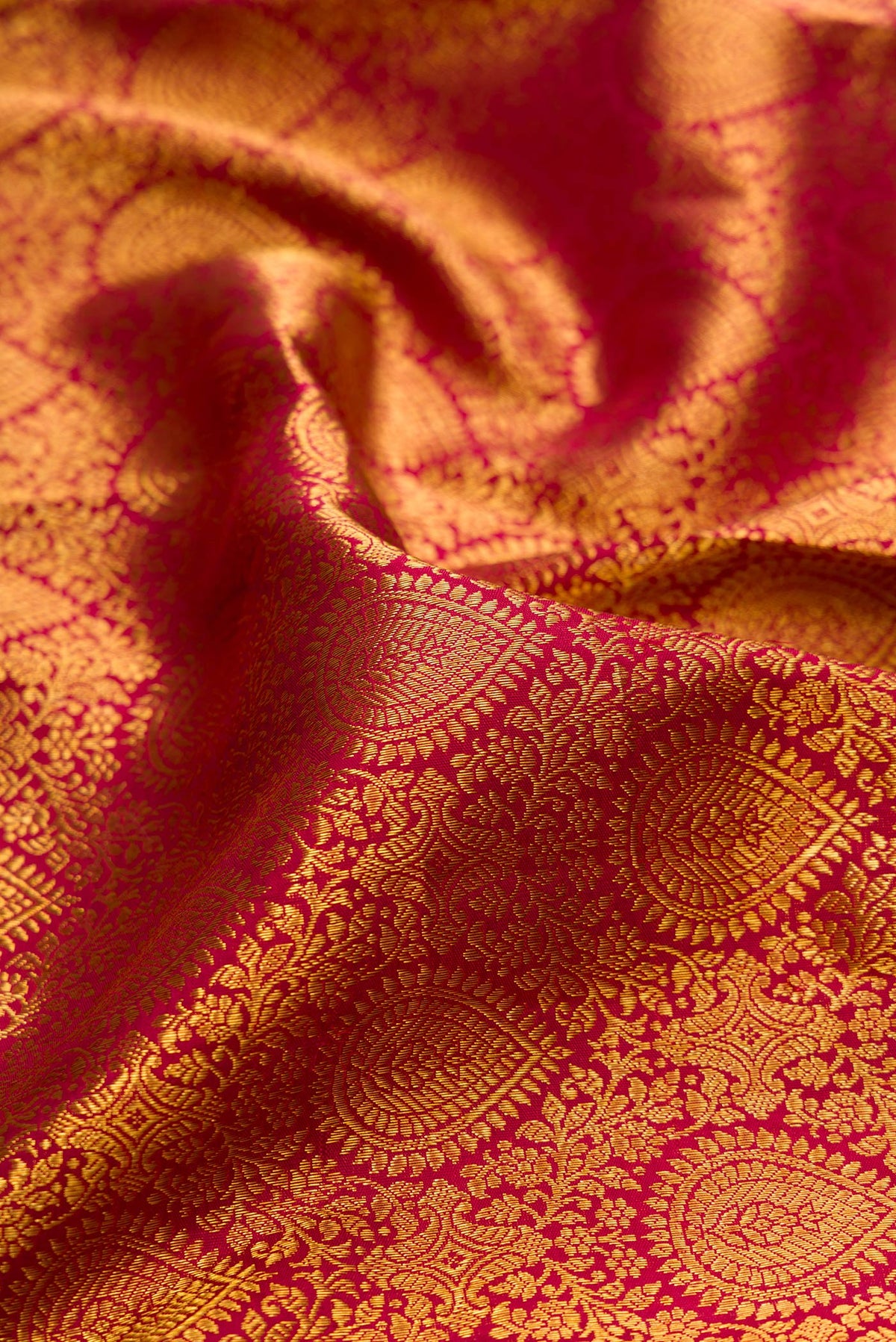 Close up of Pure Silk Maroon Kanchipuram Saree with Zari Brocade on the body and Zari Border.  displaying folds