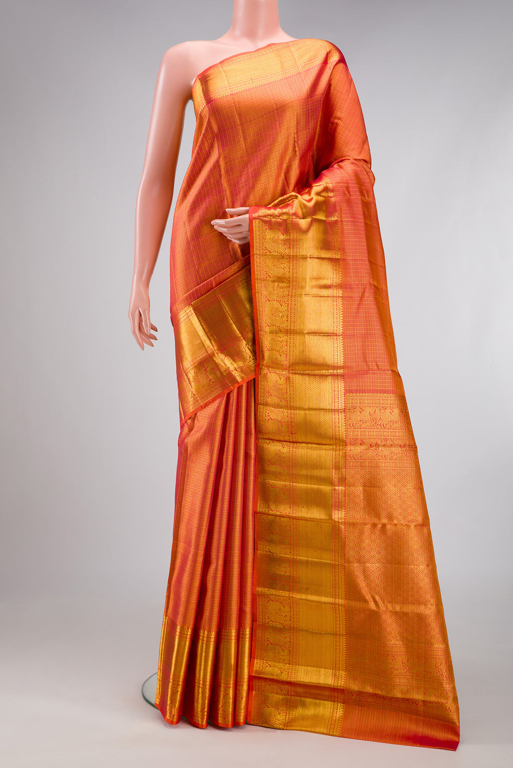 Orange Kanchipuram Silk Saree with Checked design on the body and Zari Border.  displayed on a mannequin