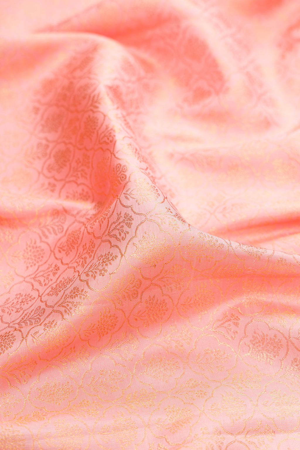Close up of Pure Silk Rose pink Kanchipuram Saree with Zari Brocade on the body and Zari Border.  displaying folds