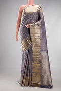 Grey Kanchipuram Silk Saree with Checked design on the body and Zari Border.  displayed on a mannequin