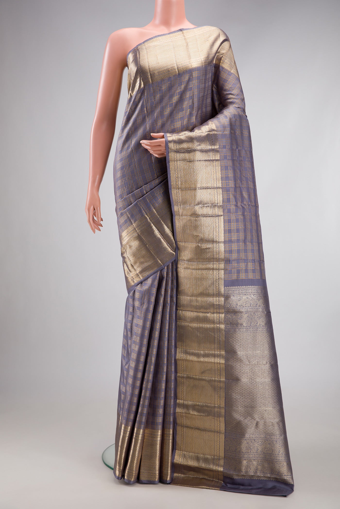 Grey Kanchipuram Silk Saree with Checked design on the body and Zari Border.  displayed on a mannequin