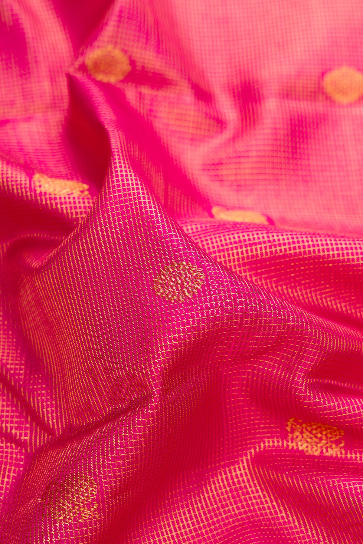 Close up of Pure Silk Dark Pink Kanchipuram Saree with Zari Brocade on the body and Zari Border.  displaying folds