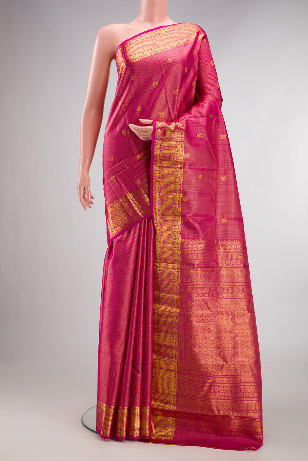 Pure Silk Dark Pink Kanchipuram Saree with Zari Brocade on the body and Zari Border.  displayed on a mannequin