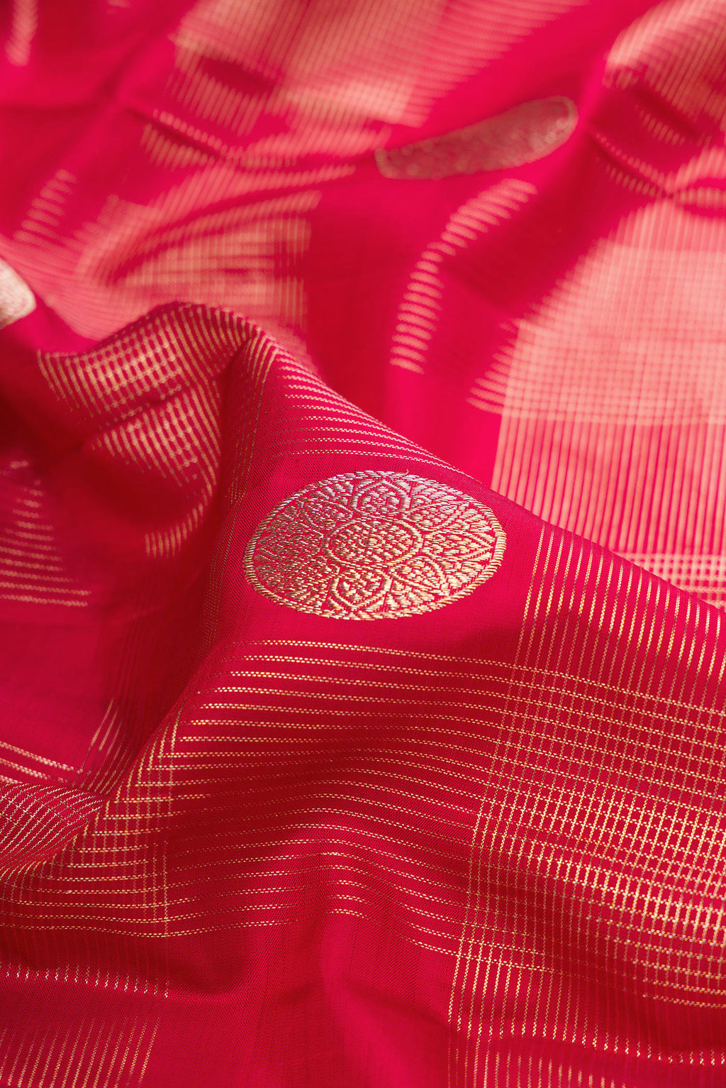 Close up of Pure Silk Maroon Kanchipuram Saree with Zari Brocade on the body and Zari Border.  displaying folds