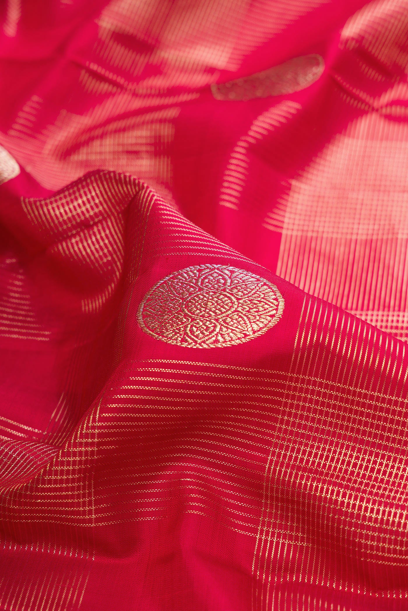 Close up of Pure Silk Maroon Kanchipuram Saree with Zari Brocade on the body and Zari Border.  displaying folds
