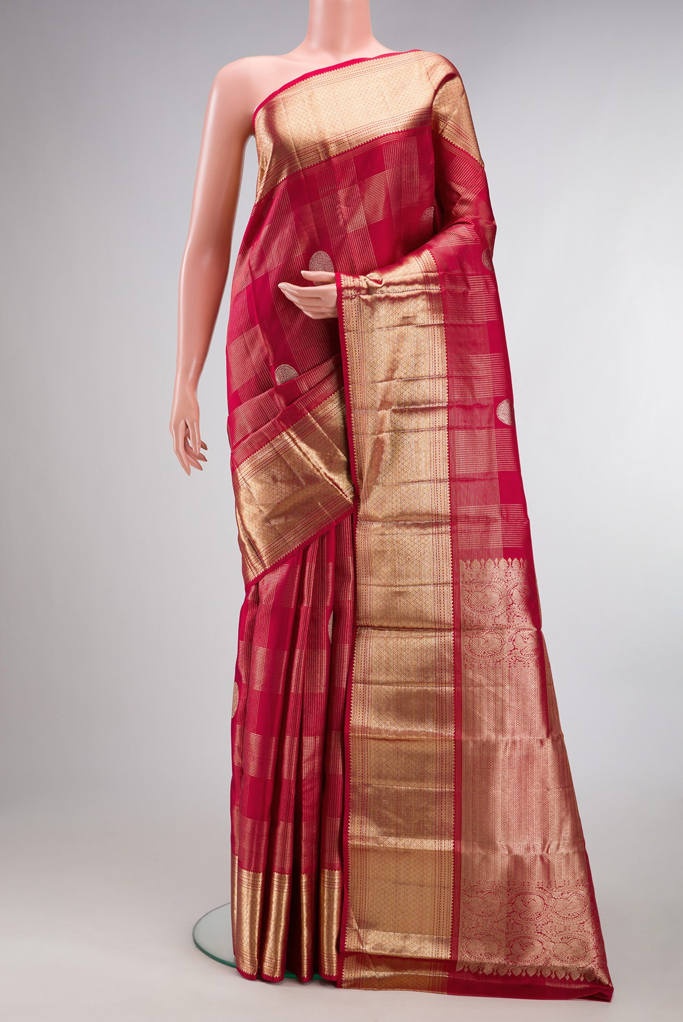 Pure Silk Maroon Kanchipuram Saree with Zari Brocade on the body and Zari Border.  displayed on a mannequin