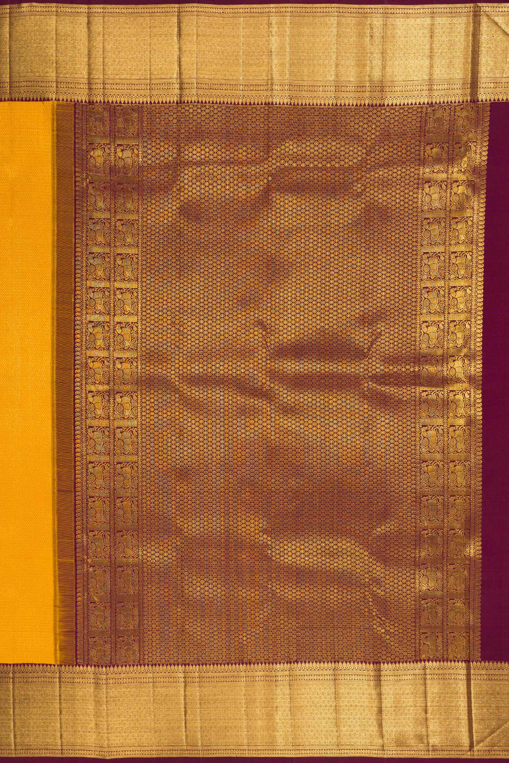 Close up image of the pallu of Pure Silk Yellow Kanchipuram Saree with Zari Brocade on the body and Zari Border. 