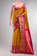 Mustard Kanchipuram Tissue Saree with Zari Brocade on the body and Zari Border.  displayed on a mannequin