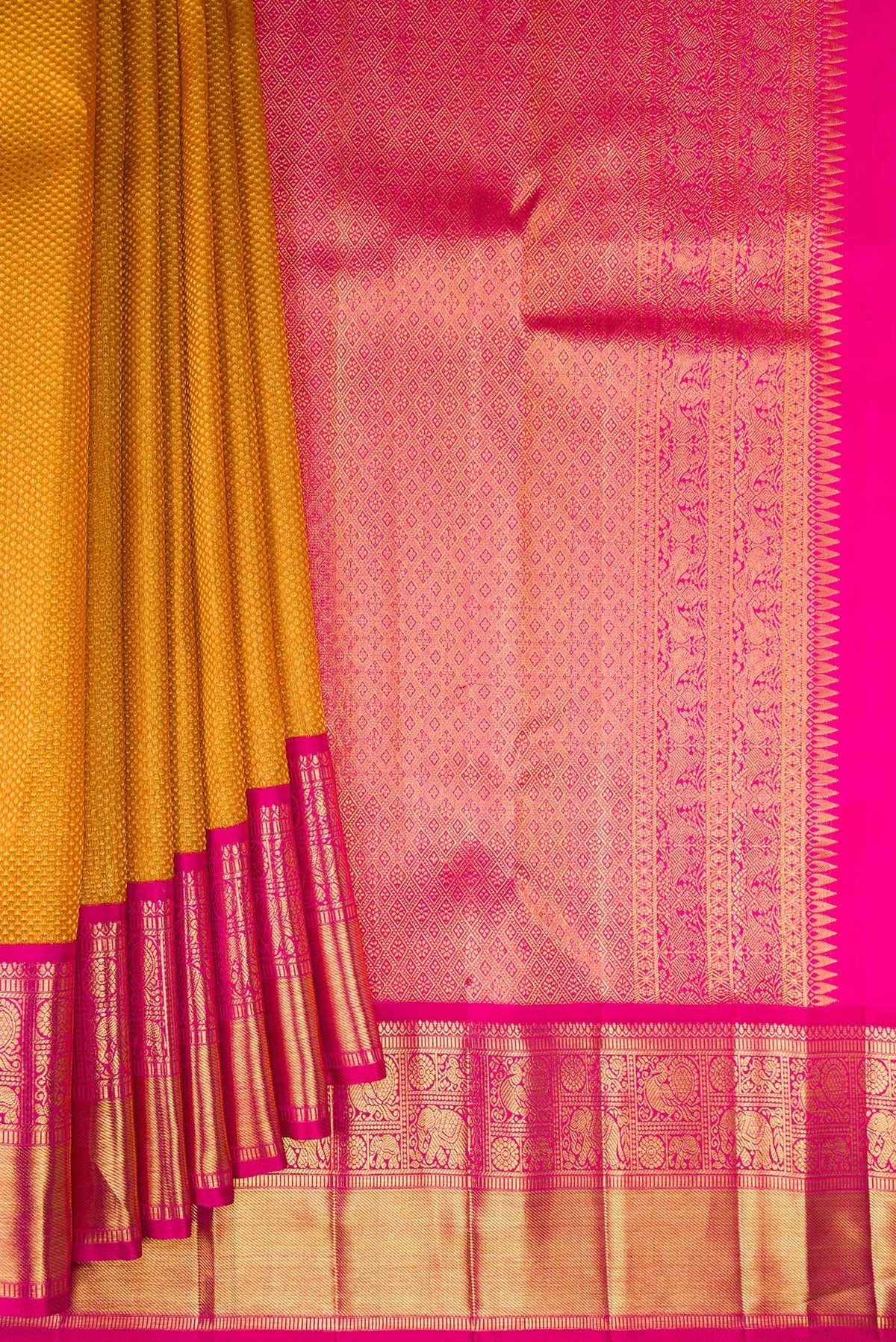 Pleats and pallu of Mustard Kanchipuram Tissue Saree with Zari Brocade on the body and Zari Border. 