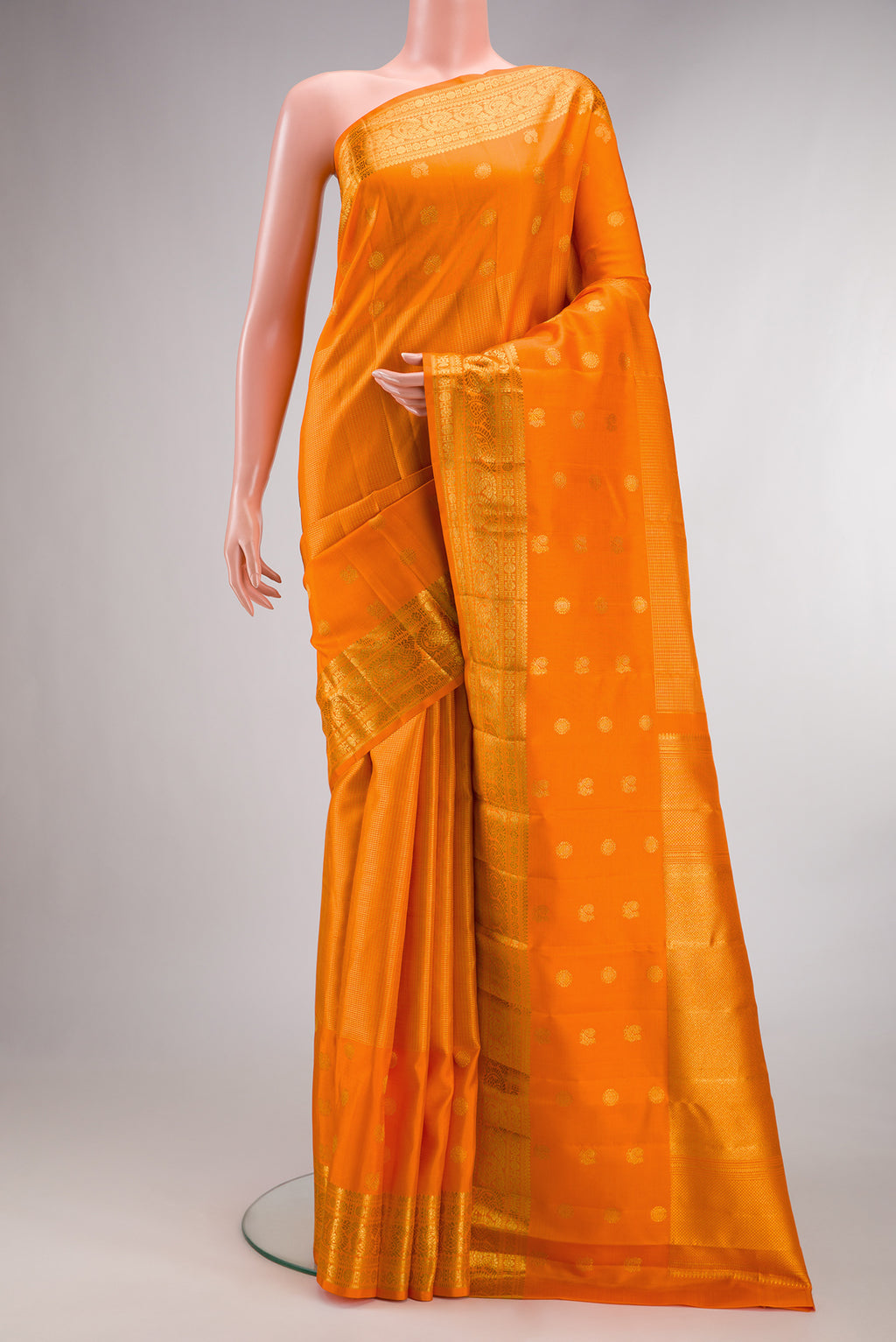 Pure Silk Orange Kanchipuram Saree with Checked design on the body and Fancy Border.  displayed on a mannequin