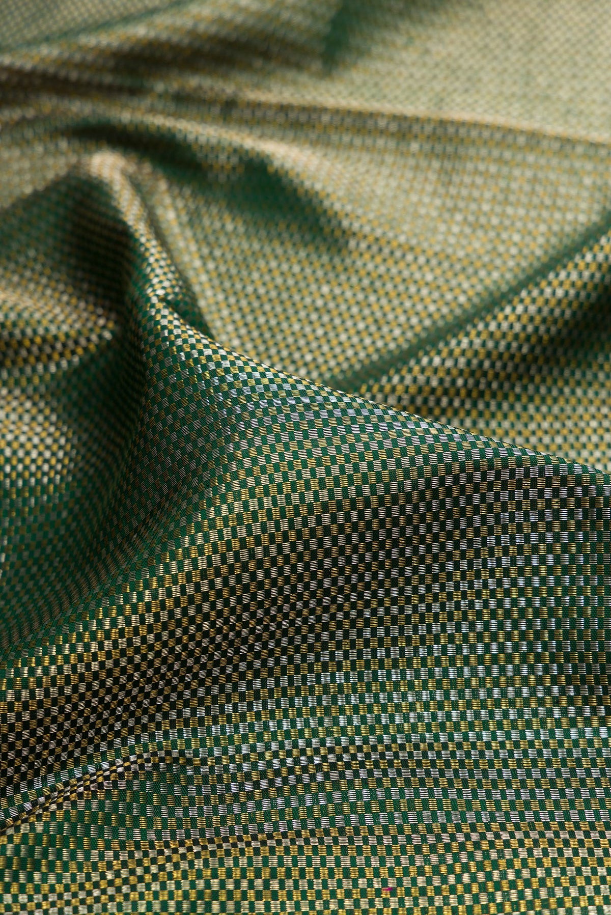 Close up of Pure Silk Bottle Green Kanchipuram Saree with Zari Brocade on the body and Fancy Border.  displaying folds