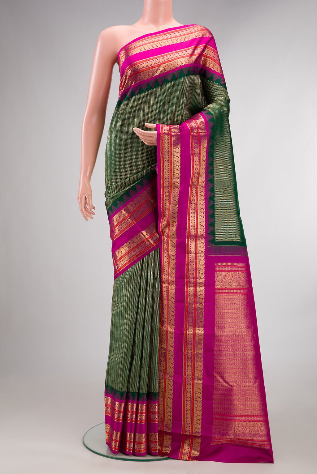 Pure Silk Bottle Green Kanchipuram Saree with Zari Brocade on the body and Fancy Border.  displayed on a mannequin