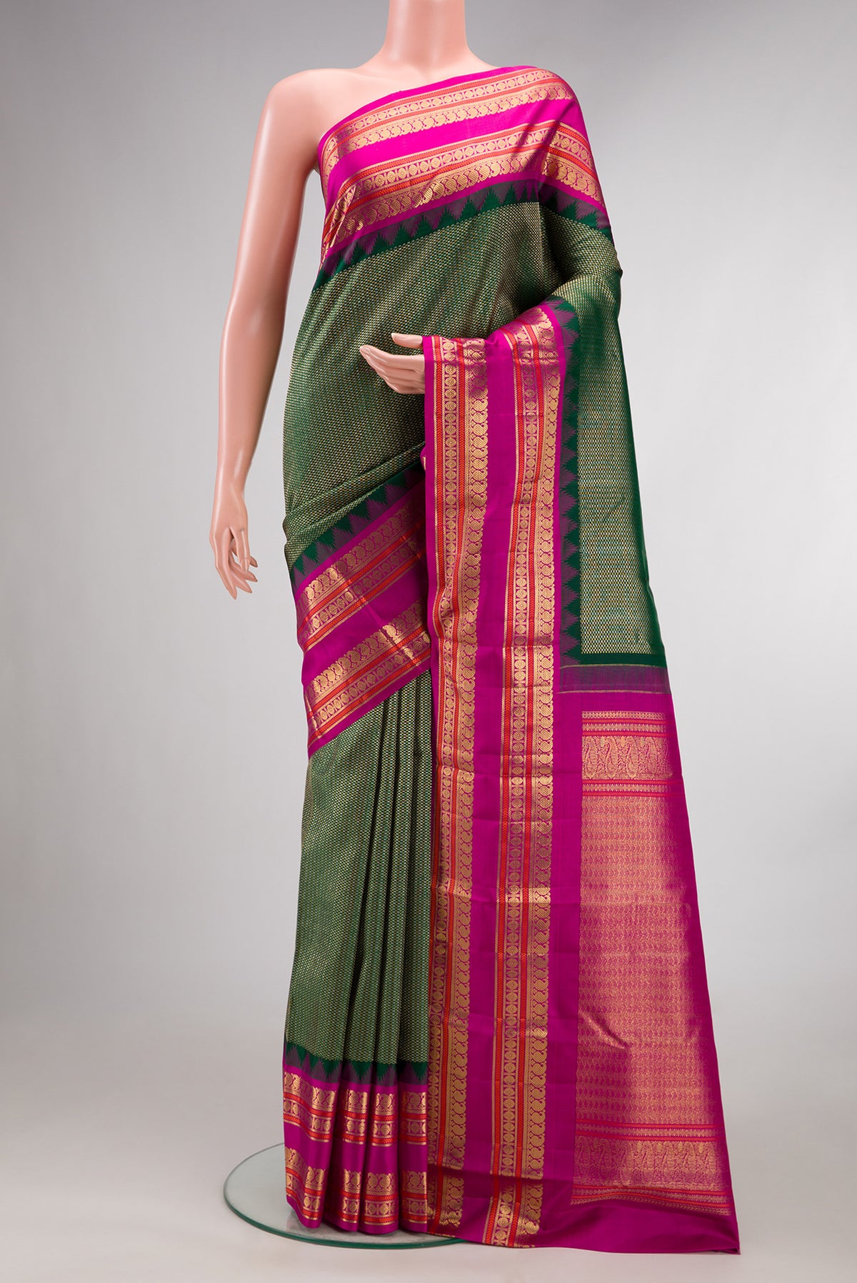 Pure Silk Bottle Green Kanchipuram Saree with Zari Brocade on the body and Fancy Border.  displayed on a mannequin