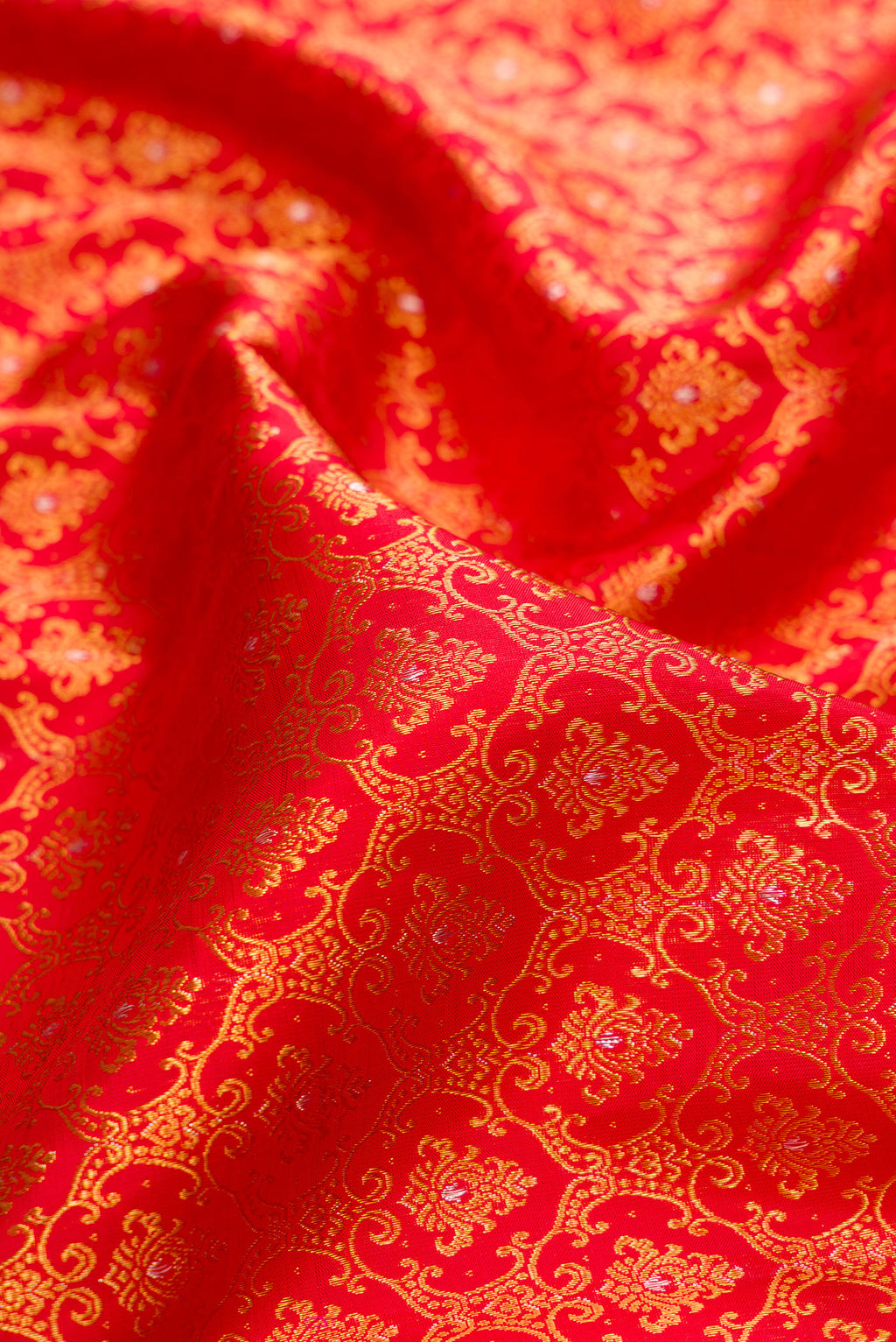 Close up of Pure Silk Red Kanchipuram Saree with Zari Brocade on the body and Fancy Border.  displaying folds