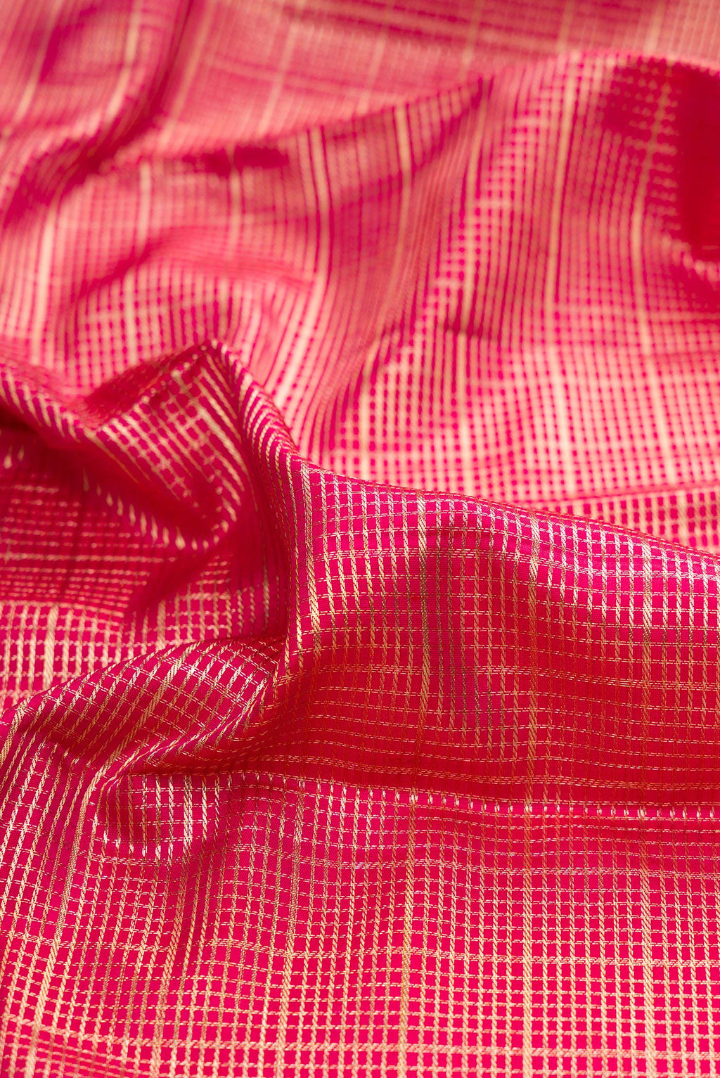 Close up of Pure Silk Dark Pink Kanchipuram Saree with Zari Brocade on the body and Fancy Border.  displaying folds