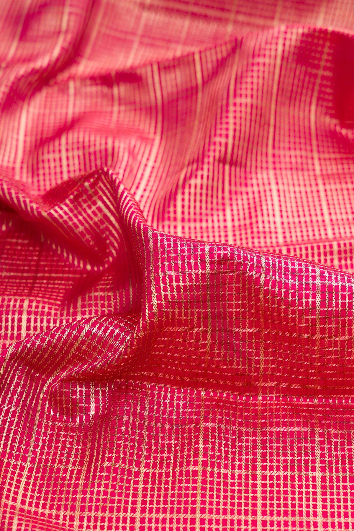 Close up of Pure Silk Dark Pink Kanchipuram Saree with Zari Brocade on the body and Fancy Border.  displaying folds