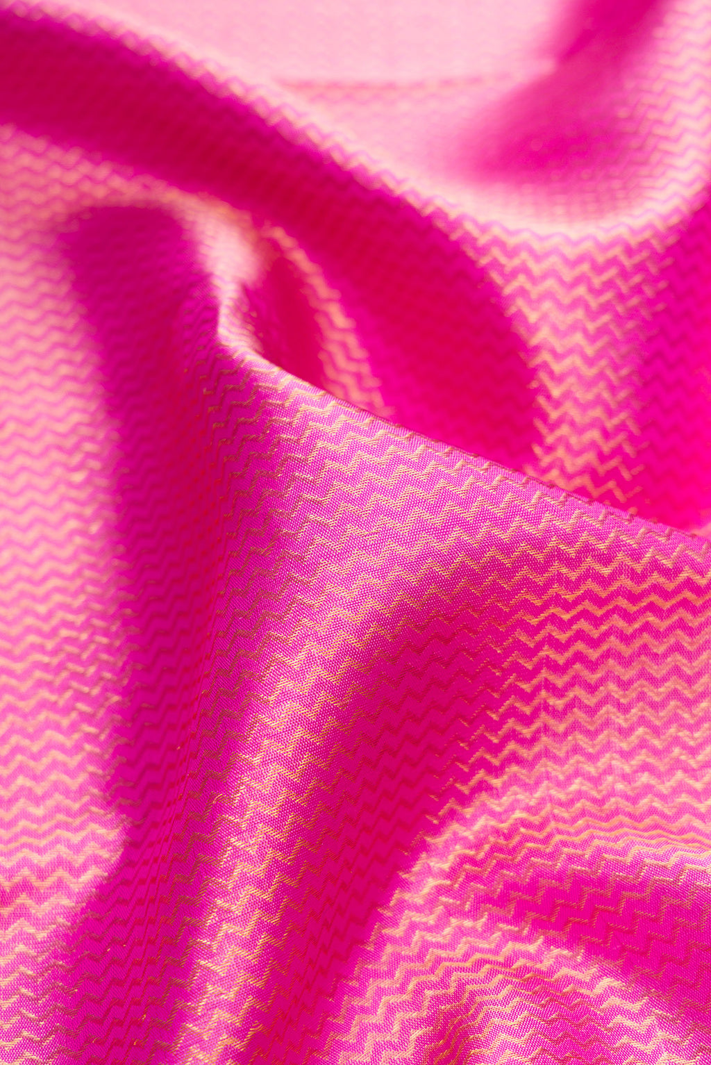 Close up of Pure Silk Rose pink Kanchipuram Saree with Zari Brocade on the body and Fancy Border.  displaying folds