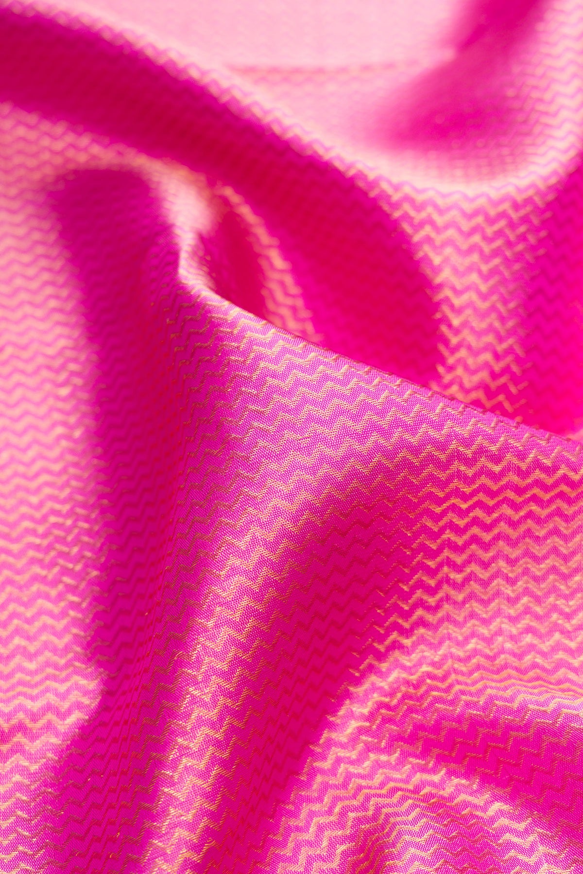 Close up of Pure Silk Rose pink Kanchipuram Saree with Zari Brocade on the body and Fancy Border.  displaying folds