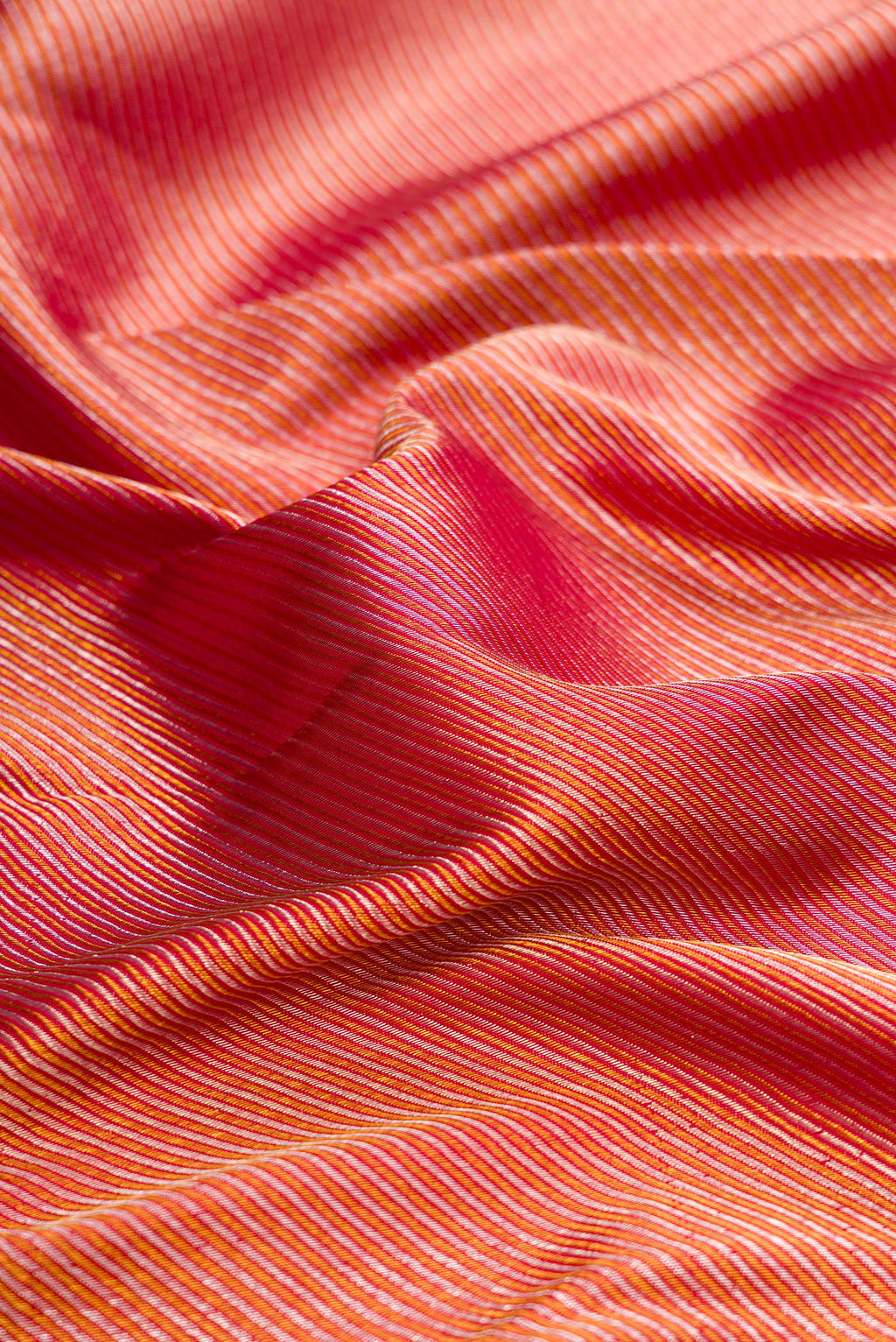 Close up of Pure Silk Maroon Dual Tone Kanchipuram Saree with Zari Brocade on the body and Zari Border.  displaying folds