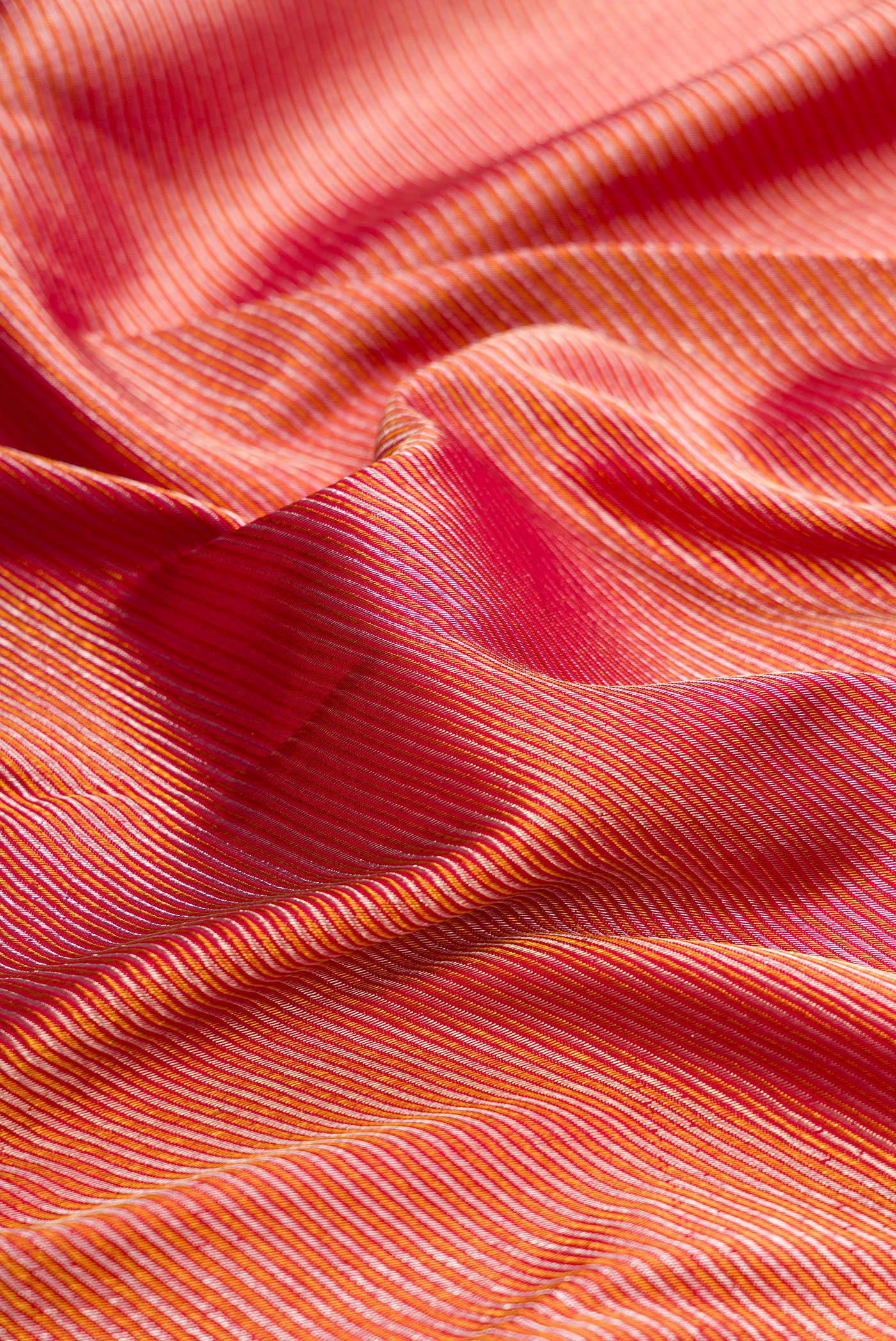 Close up of Pure Silk Maroon Dual Tone Kanchipuram Saree with Zari Brocade on the body and Zari Border.  displaying folds