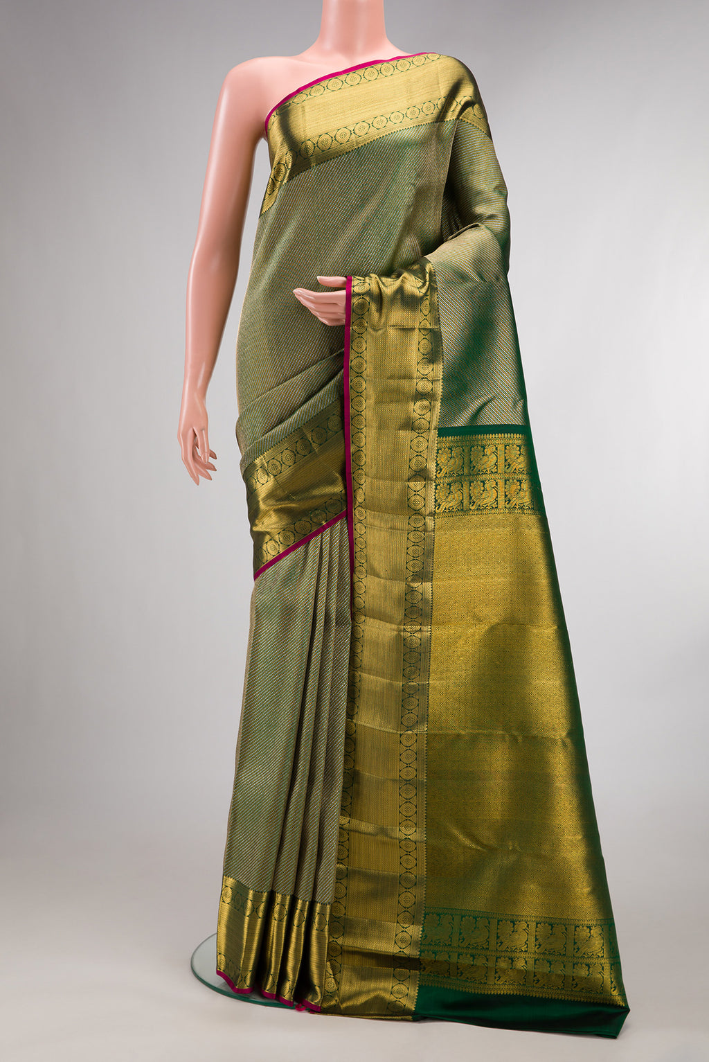 Pure Silk Bottle Green Kanchipuram Saree with Zari Brocade on the body and Zari Border.  displayed on a mannequin
