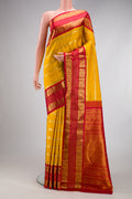 Yellow Kanchipuram Silk Saree with Stripes on the body and Zari Border.  displayed on a mannequin