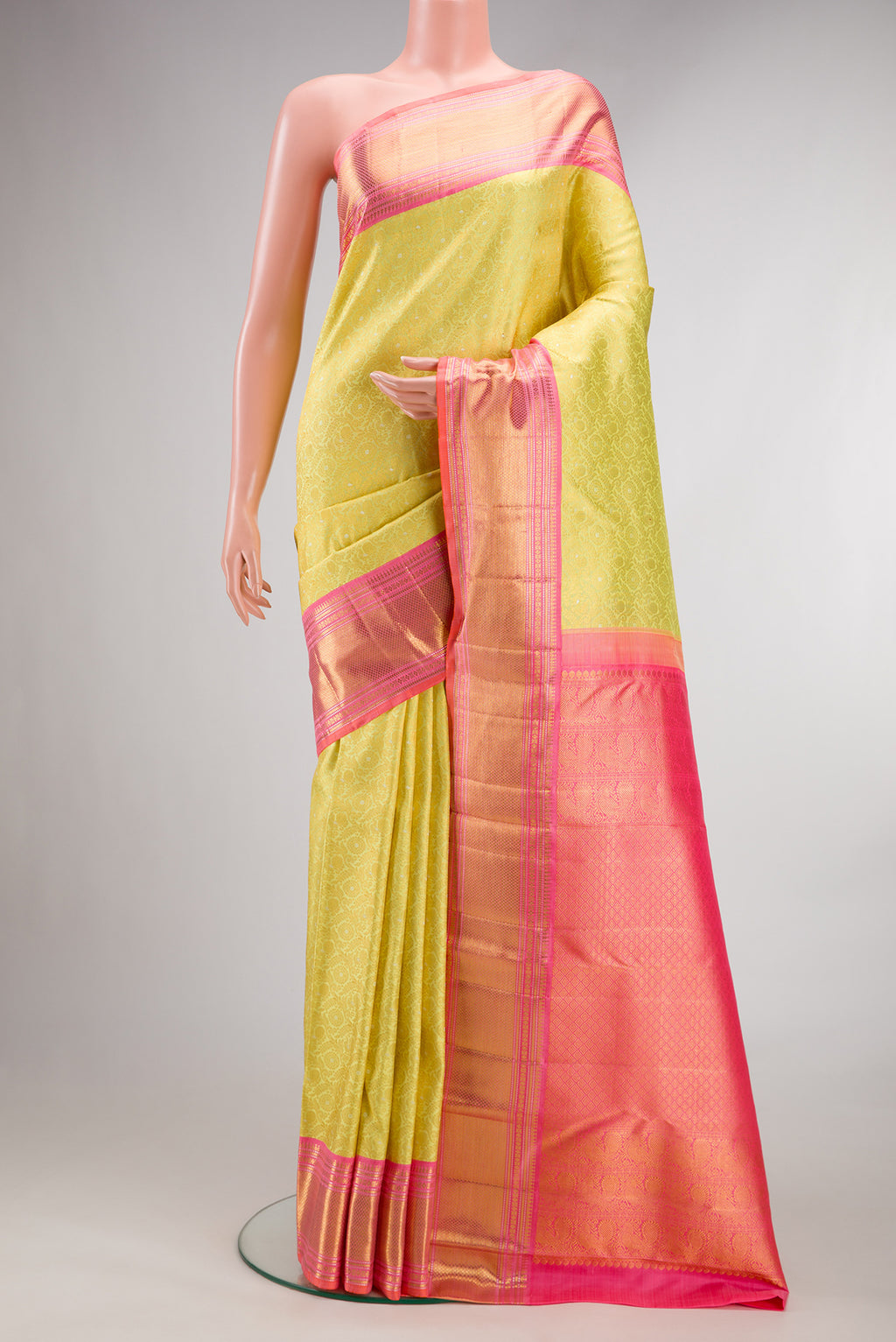 Pure Silk Lemon Yellow Kanchipuram Saree with Zari Brocade on the body and Zari Border.  displayed on a mannequin