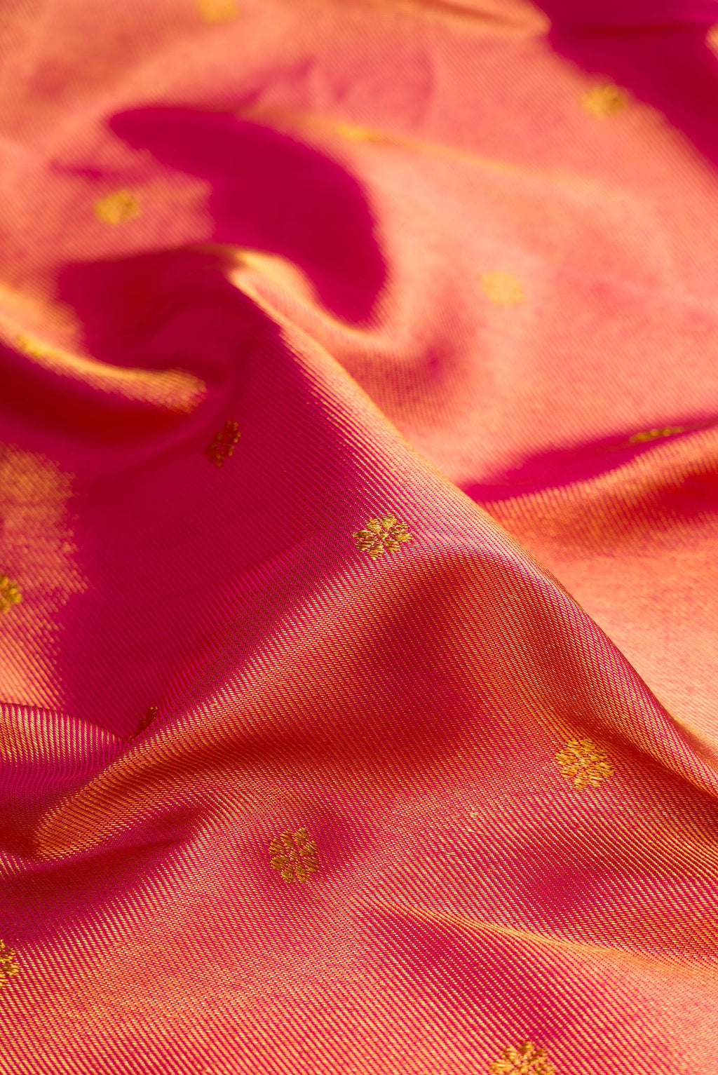 Close up of Dark Pink Kanchipuram Silk Saree with Zari Brocade on the body and Zari Border.  displaying folds