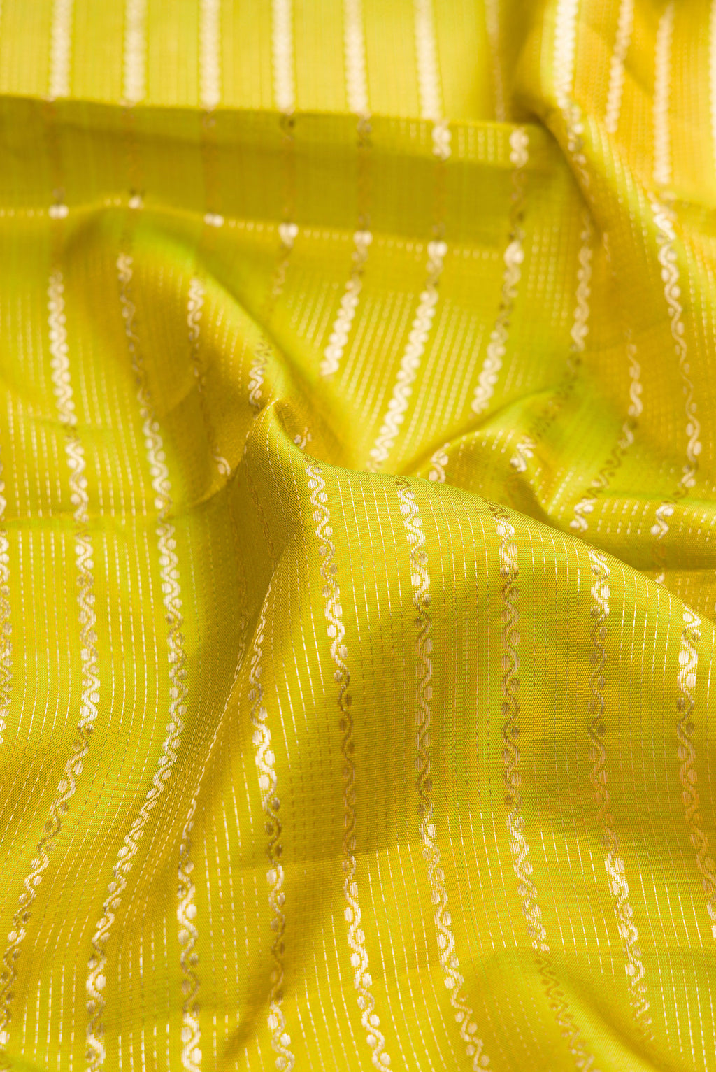 Close up of Pure Silk Parrot Green Kanchipuram Saree with Stripes on the body and Fancy Border.  displaying folds