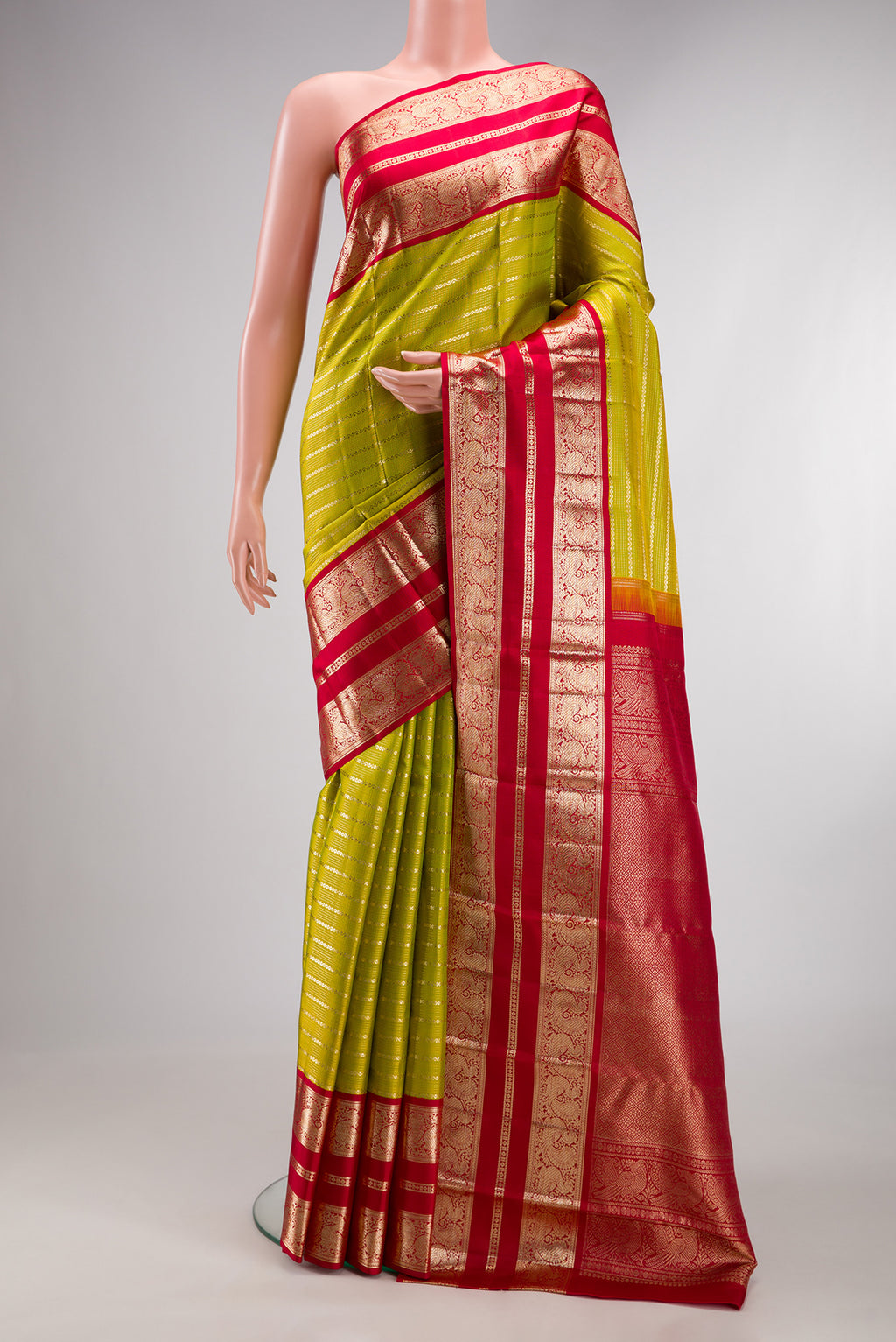 Pure Silk Parrot Green Kanchipuram Saree with Stripes on the body and Fancy Border.  displayed on a mannequin