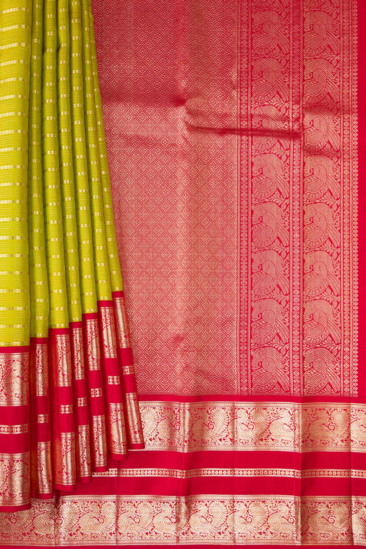 Pleats and pallu of Pure Silk Parrot Green Kanchipuram Saree with Stripes on the body and Fancy Border. 