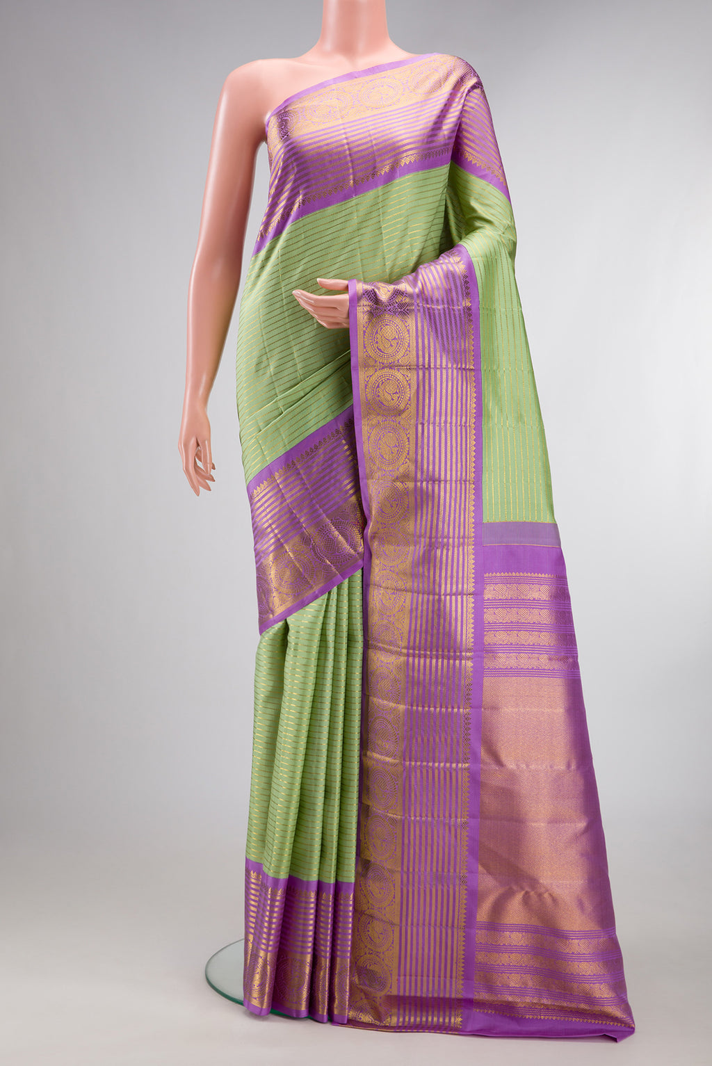 Pure Silk Pista Green Kanchipuram Saree with Stripes on the body and Zari Border.  displayed on a mannequin
