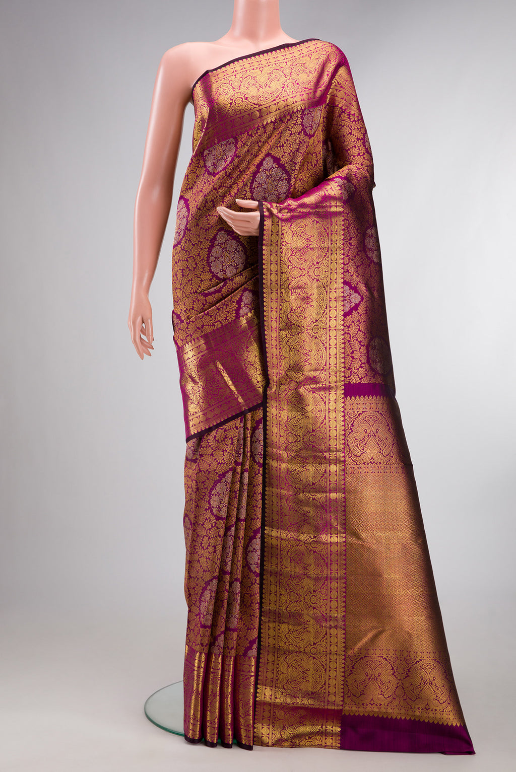 Pure Silk Magenta Kanjivaram Saree with Zari Brocade on the body and Zari Border.  displayed on a mannequin
