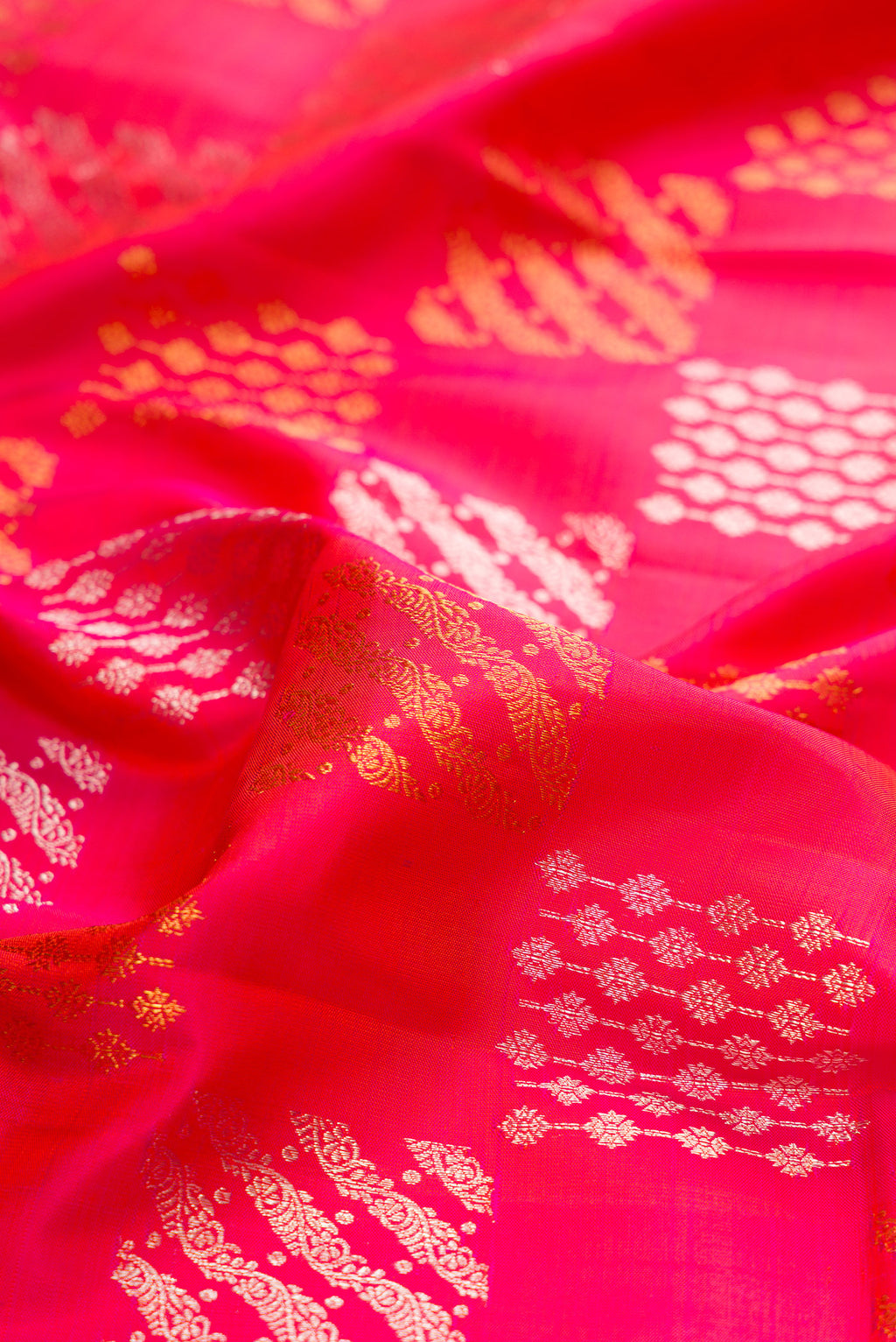 Close up of Pink Kanjivaram Silk Saree with Zari Brocade on the body and Zari Border.  displaying folds