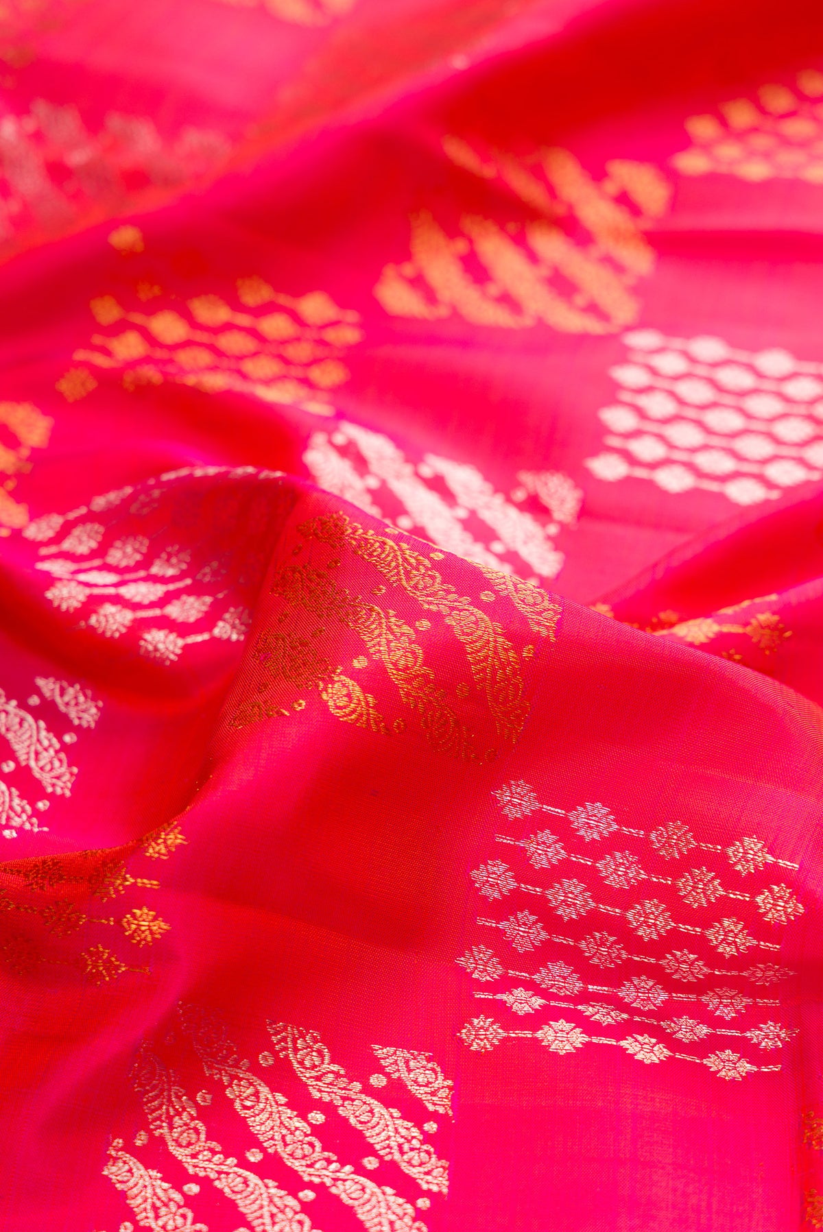 Close up of Pink Kanjivaram Silk Saree with Zari Brocade on the body and Zari Border.  displaying folds